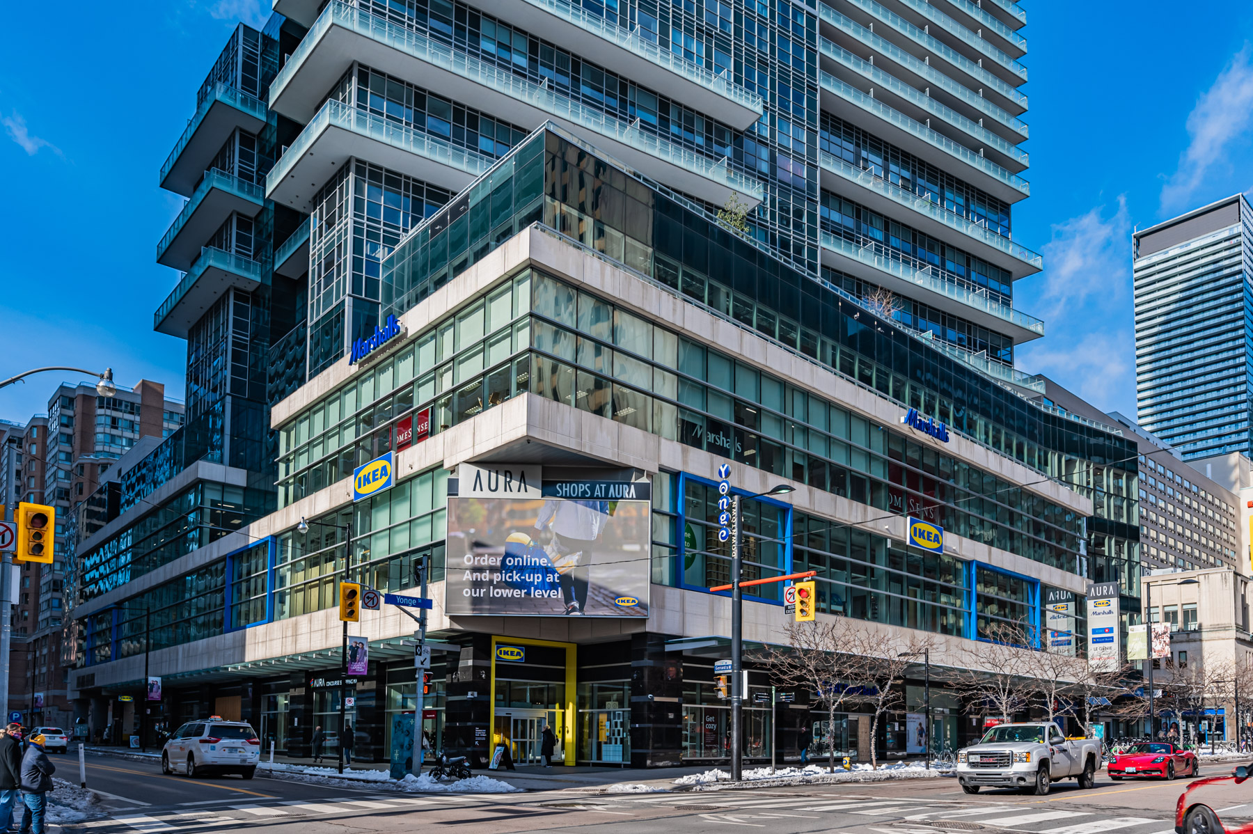 Exterior of Aura Condos glass podium with IKEA and Marshalls stores.