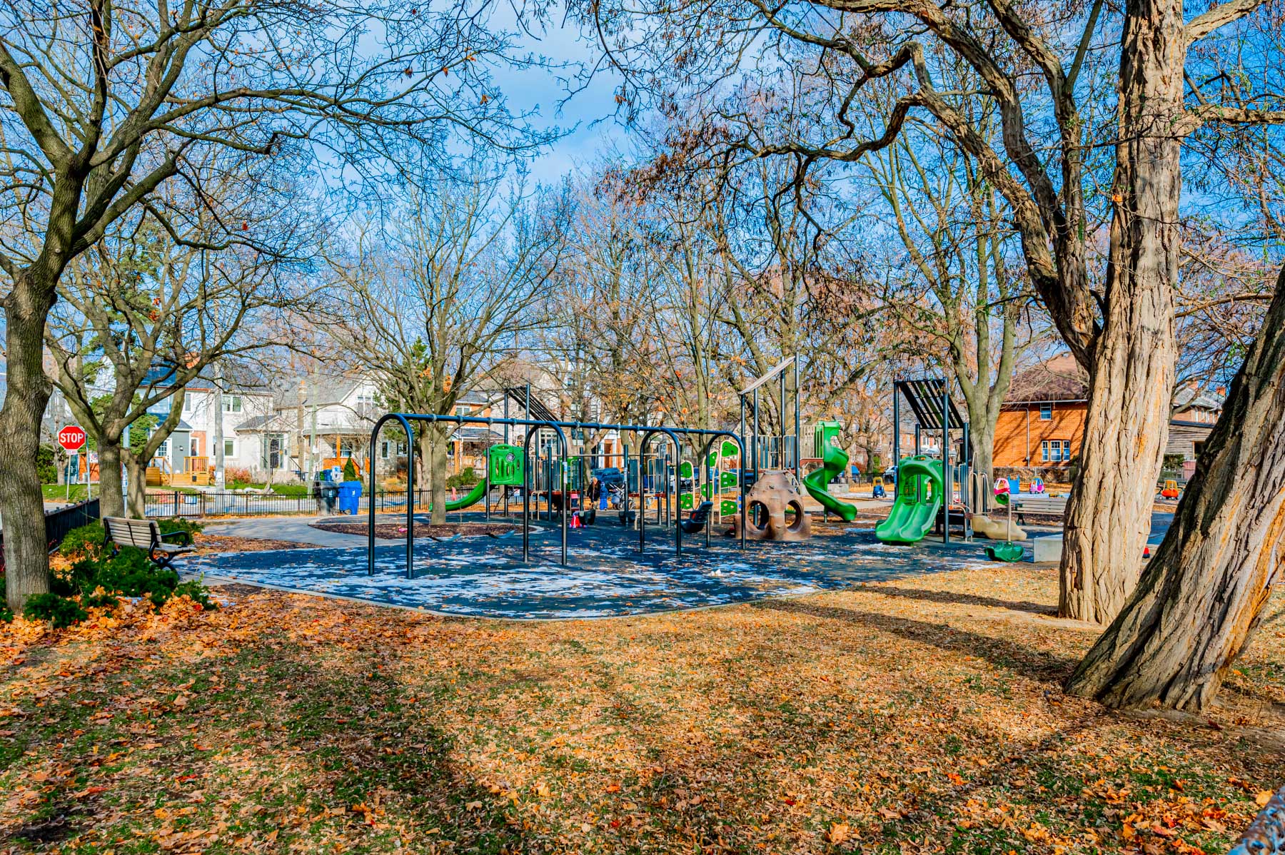 Playground equipment and trees at Woburn Ave Playground.