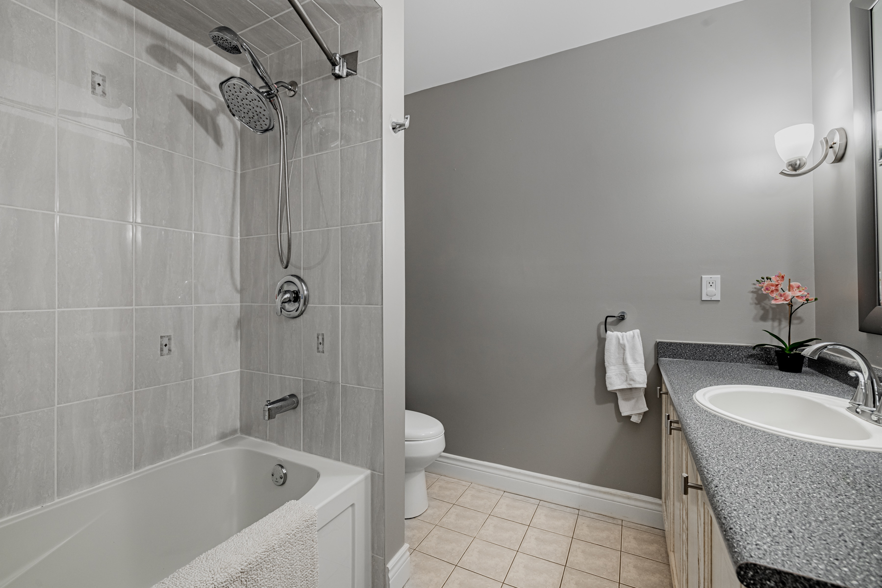 17. 77 Schouten Cresc Bathroom with gray walls tiles counters 77 Schouten Cres 3-piece bath with gray walls, tiles and counters.