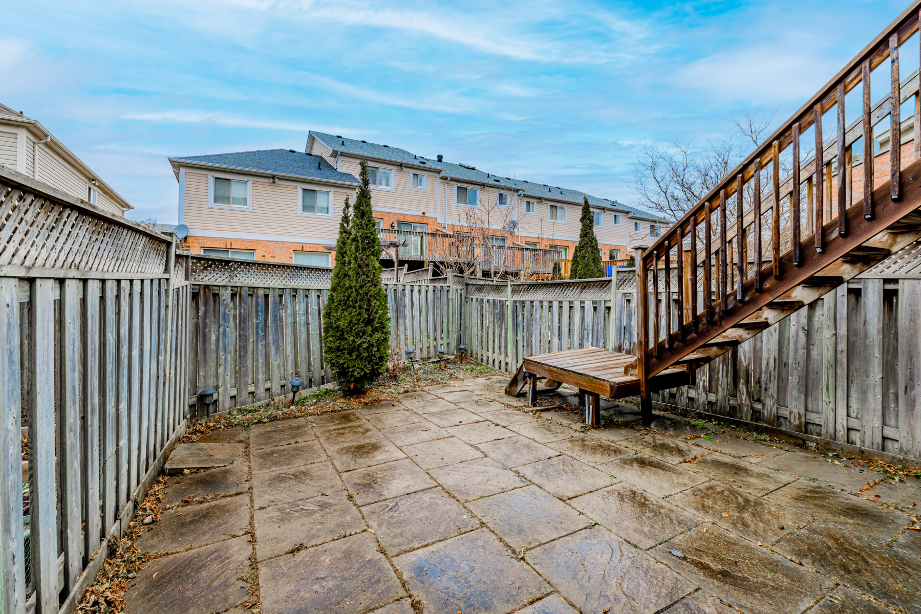 21. Backyard with stone floors and wood fence Large backyard with fence.