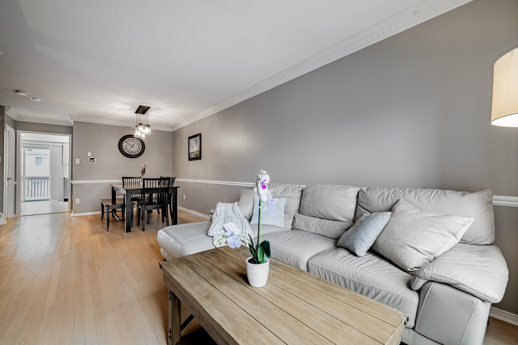 3. 77 Schouten Crescent Living dining room with gray walls crown moulding wainscoting Living and dining room with gray walls, crown moulding and wainscoting.