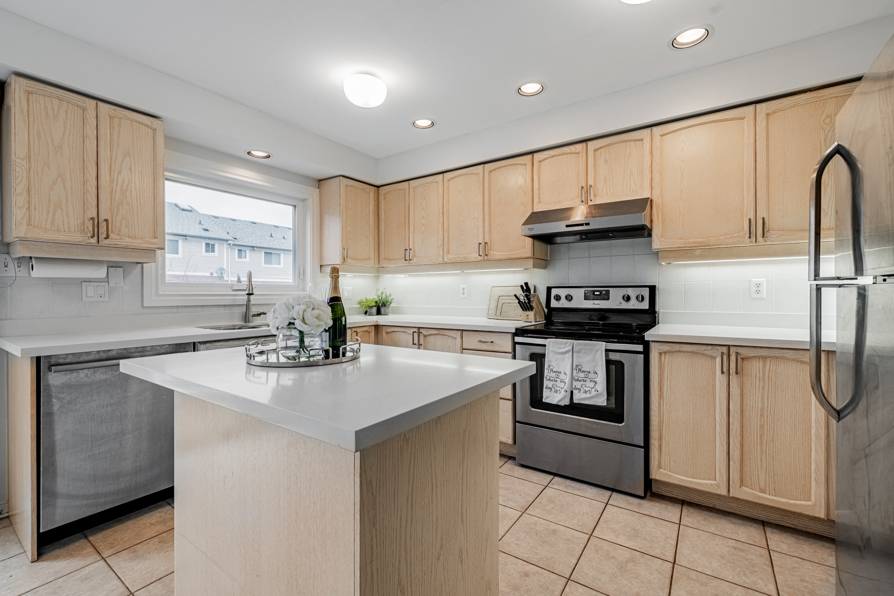 7. Brightly lit kitchen 77 Schouten Cres Kitchen lit by window, ceiling lamps and pot lights.