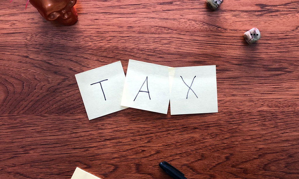 3 sticky notes spelling "TAX" to show Vacant Home Tax.